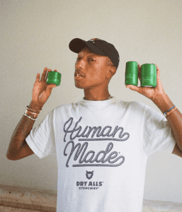 Pharrell Williams Holding His Skincare Products