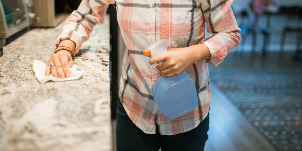 woman cleaning countertop